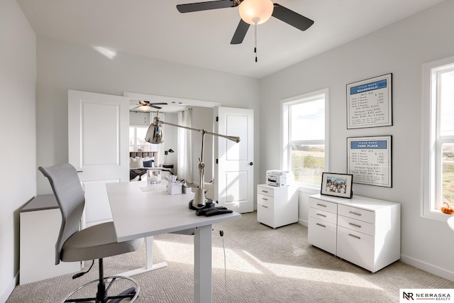 home office featuring a wealth of natural light and light colored carpet