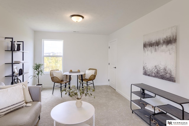 sitting room featuring light carpet