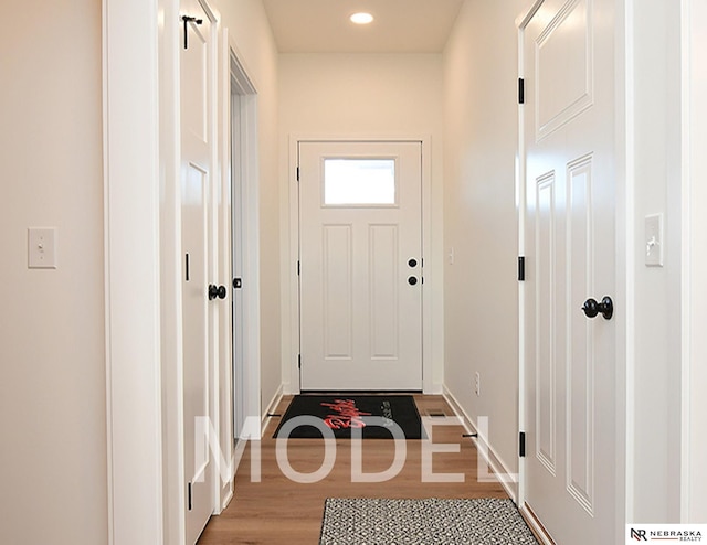 14803 Willow St, Bennington, NE 68007 - doorway to outside featuring light wood-type flooring, baseboards, and recessed lighting