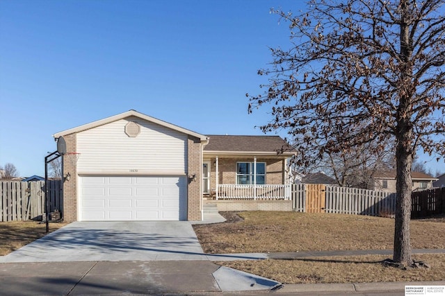 single story home with a garage and covered porch