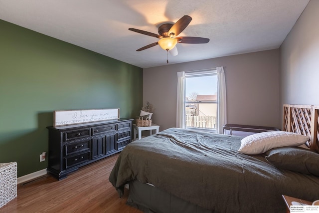 bedroom with ceiling fan and hardwood / wood-style floors