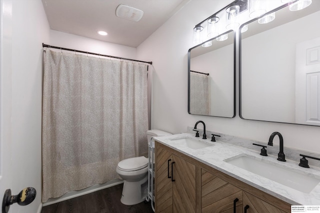 bathroom with vanity, hardwood / wood-style flooring, and toilet