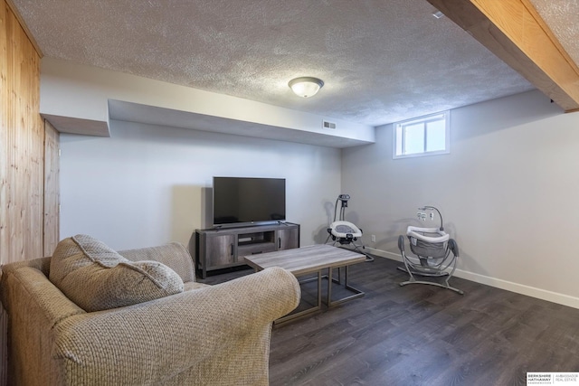 living room featuring dark wood-type flooring and a textured ceiling