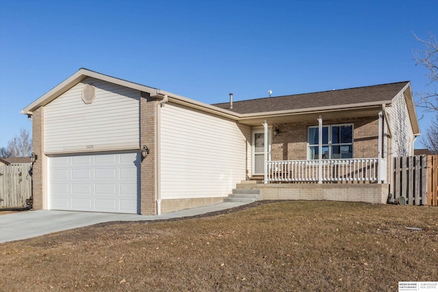 single story home featuring a garage, covered porch, and a front yard