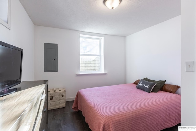 bedroom with electric panel and dark hardwood / wood-style flooring