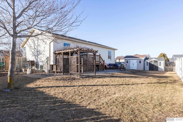 back of house featuring a patio, a deck, a lawn, a pergola, and a storage shed