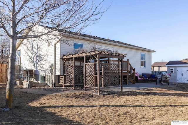 back of house featuring a storage shed and a patio