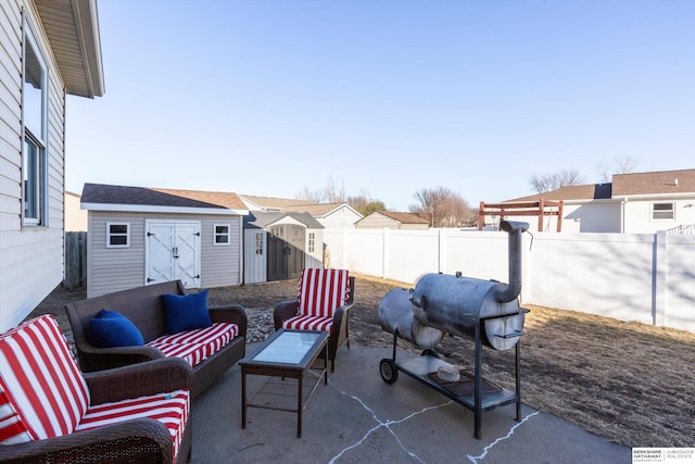 view of patio / terrace with grilling area and a storage unit