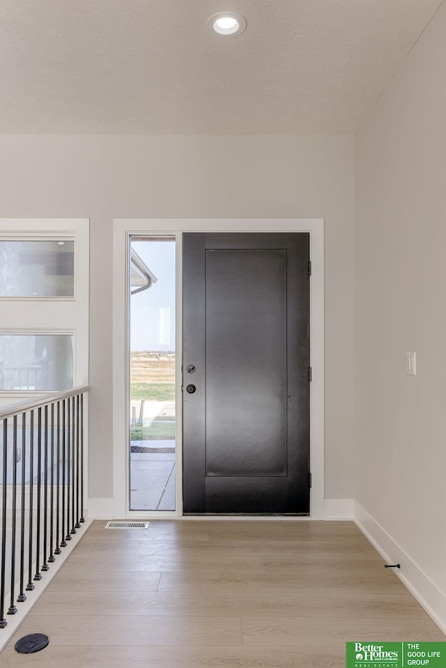 doorway with light hardwood / wood-style flooring