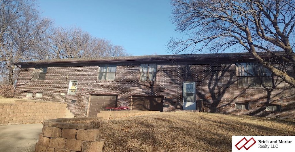 rear view of property featuring a garage