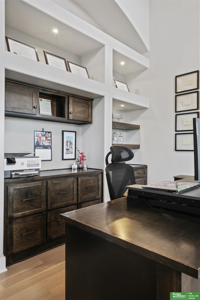 kitchen with dark brown cabinets and light hardwood / wood-style floors