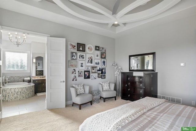 carpeted bedroom featuring beamed ceiling, coffered ceiling, an inviting chandelier, and ensuite bath