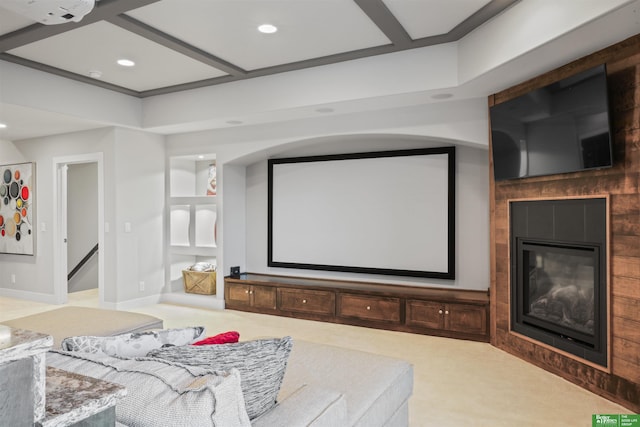 home theater room with coffered ceiling and carpet floors