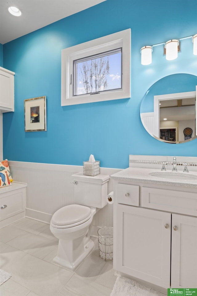 bathroom with vanity, toilet, and tile patterned flooring