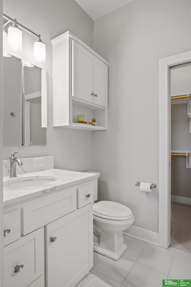 bathroom with vanity, tile patterned floors, and toilet