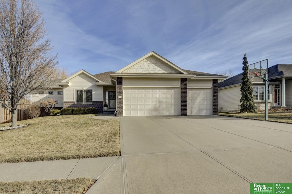 view of front of house featuring a garage and a front lawn