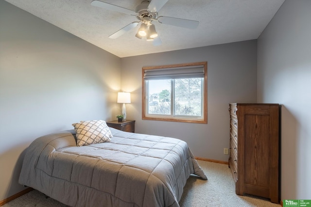 bedroom with light colored carpet, a textured ceiling, and ceiling fan