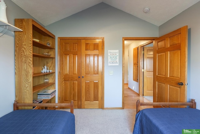 bedroom featuring carpet flooring and vaulted ceiling