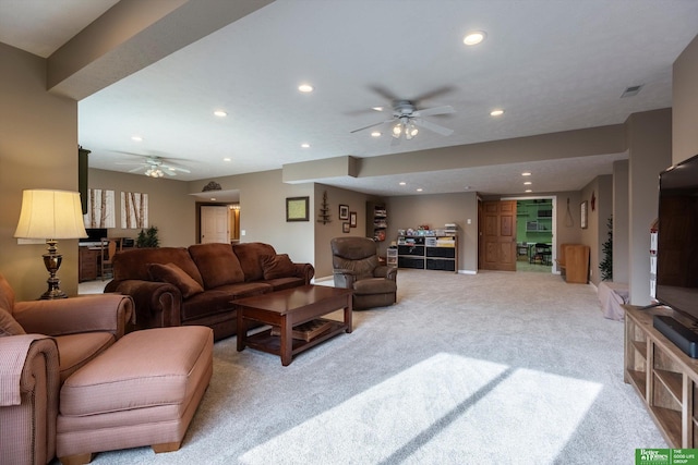 carpeted living room with ceiling fan