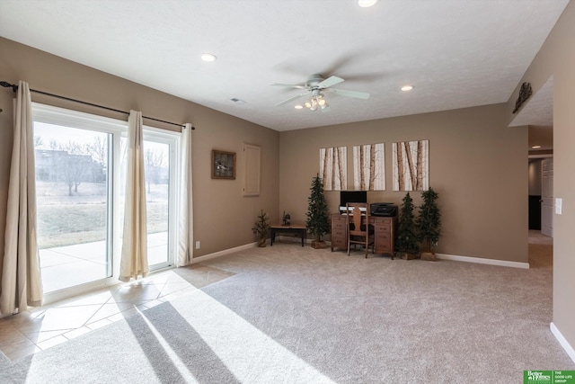 living area with ceiling fan, light carpet, and a textured ceiling