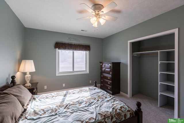 carpeted bedroom with a textured ceiling, a closet, and ceiling fan