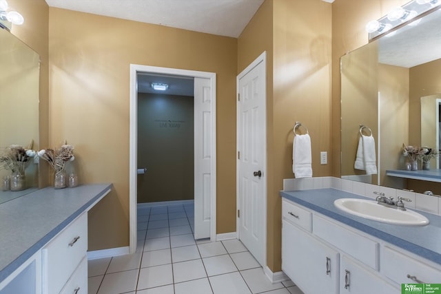 bathroom featuring tile patterned flooring and vanity