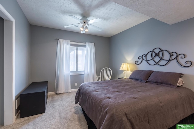 carpeted bedroom with ceiling fan and a textured ceiling