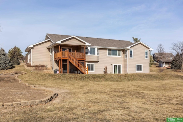 back of house featuring a wooden deck and a yard