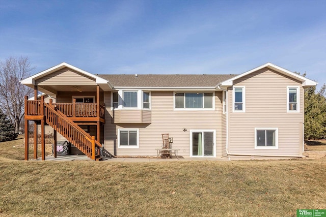 rear view of house with a lawn and a deck