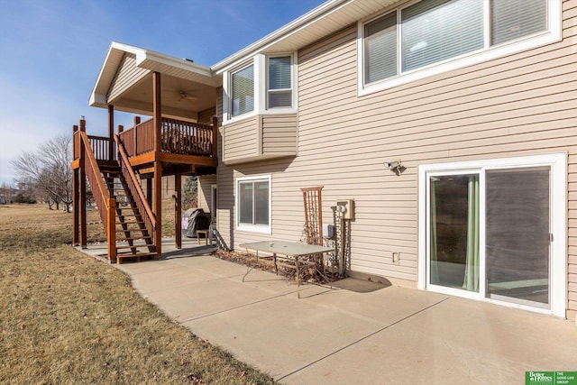 back of property featuring a patio area, a lawn, ceiling fan, and a deck