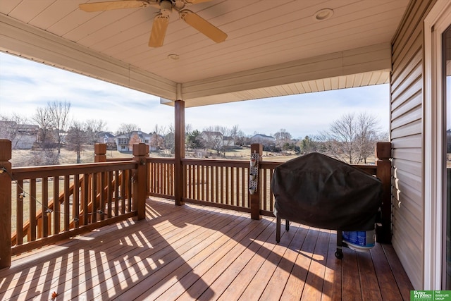 deck with grilling area and ceiling fan