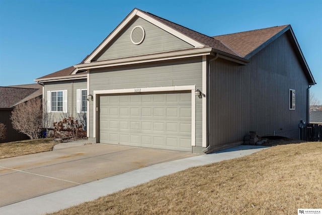 ranch-style home with a garage and a front yard