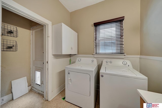 laundry area with cabinets and washing machine and clothes dryer