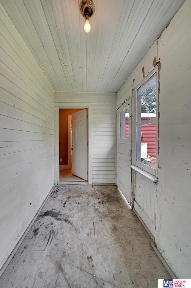 spare room featuring wood walls