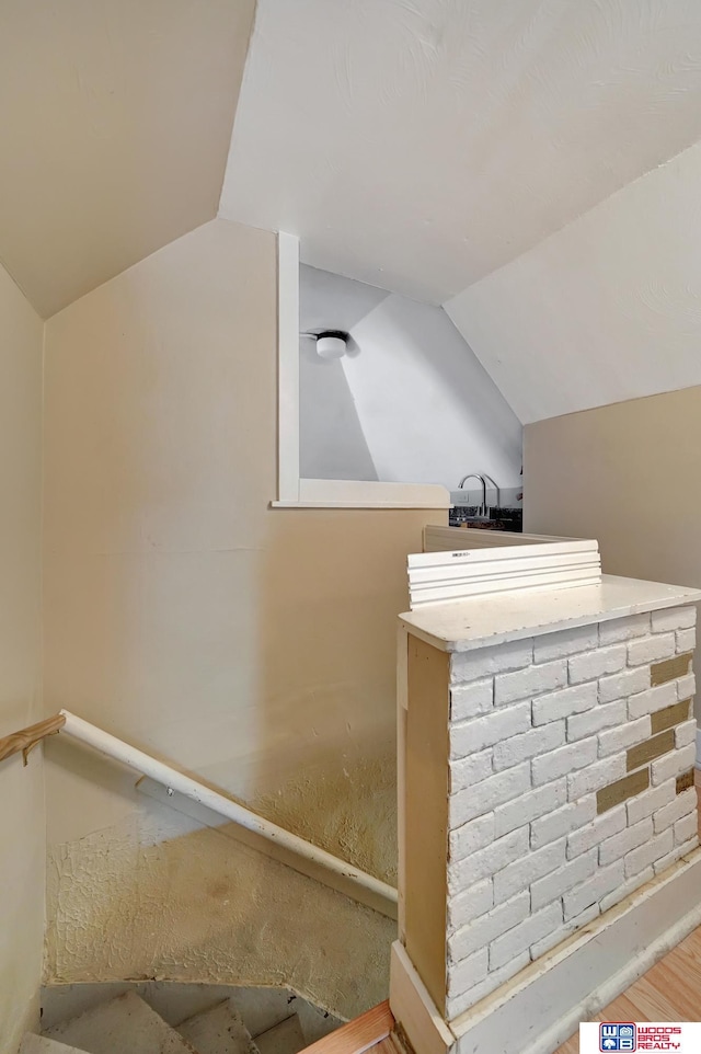 bathroom featuring lofted ceiling and hardwood / wood-style floors