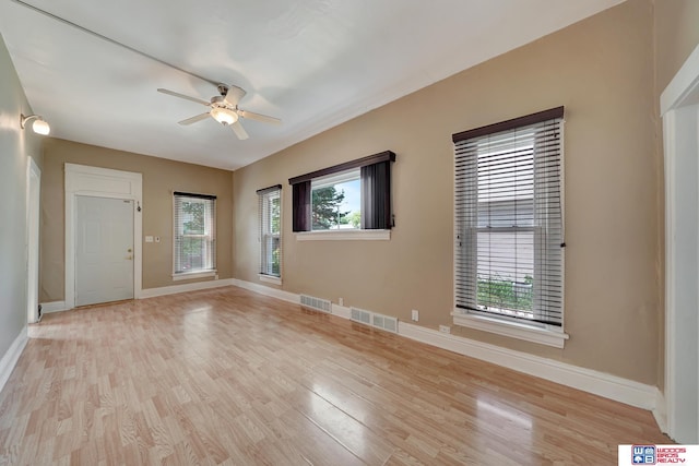 unfurnished room with ceiling fan and light hardwood / wood-style floors