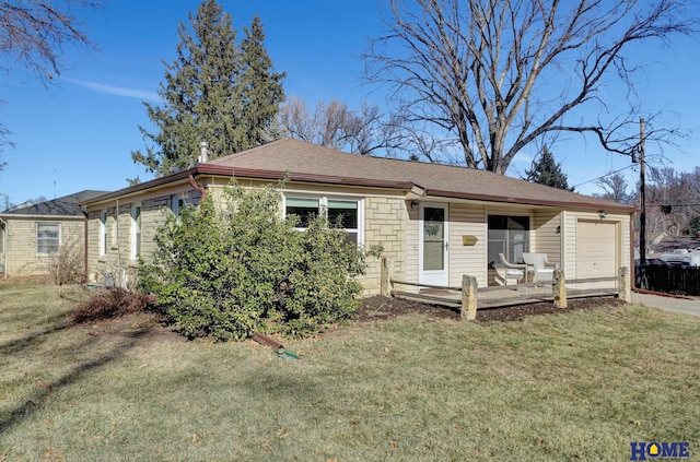 view of front of property featuring a garage and a front lawn