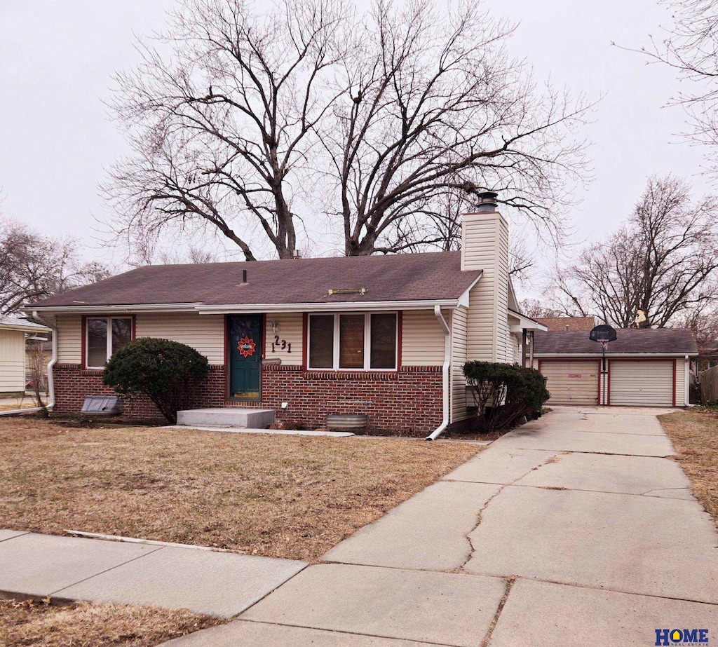 ranch-style home with a garage and a front yard