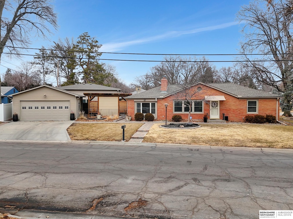 ranch-style house with a garage and a front yard