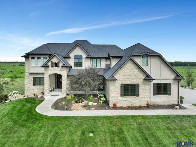 french country home featuring a front lawn