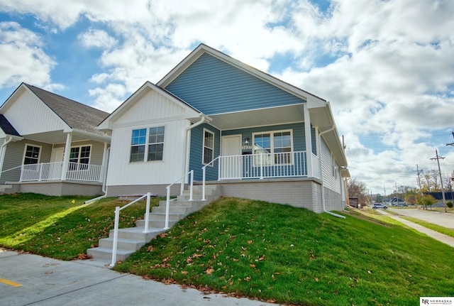 view of front of property with a porch and a front lawn