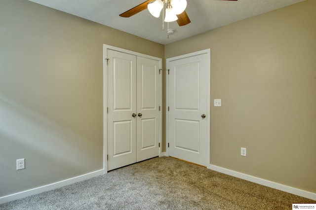 unfurnished bedroom featuring ceiling fan, carpet flooring, and a closet