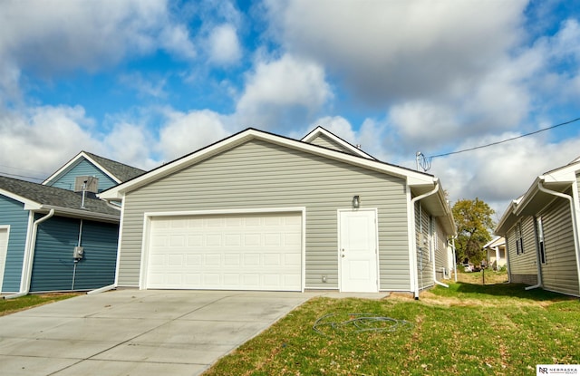 view of front of house with a garage and a front lawn