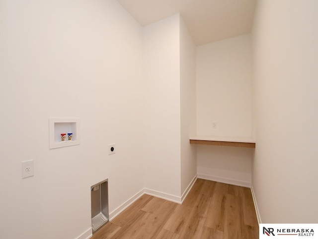 laundry area with washer hookup, light hardwood / wood-style floors, and hookup for an electric dryer