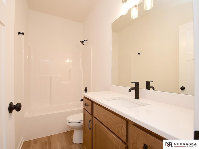 full bathroom with shower / bathtub combination, vanity, toilet, and hardwood / wood-style floors