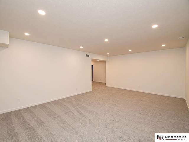 unfurnished room featuring light carpet