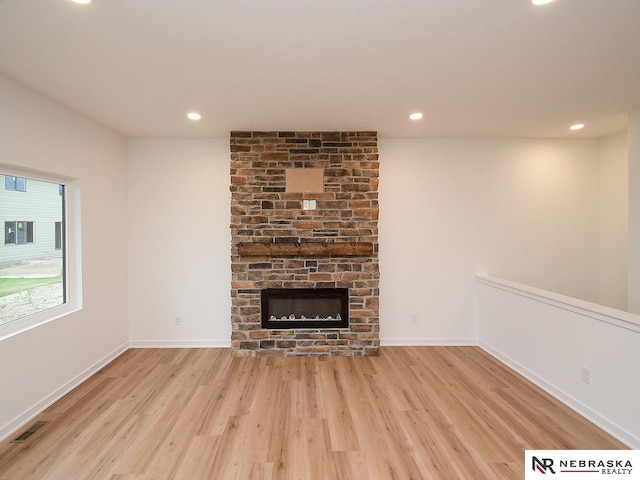 unfurnished living room with light hardwood / wood-style flooring and a fireplace