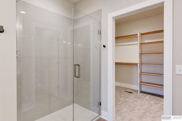 bathroom with a shower with door