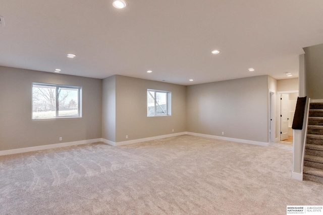 empty room featuring a healthy amount of sunlight and light colored carpet