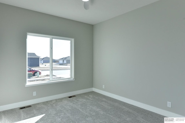 carpeted spare room with ceiling fan